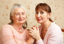 caregiver holding a hands of the old woman